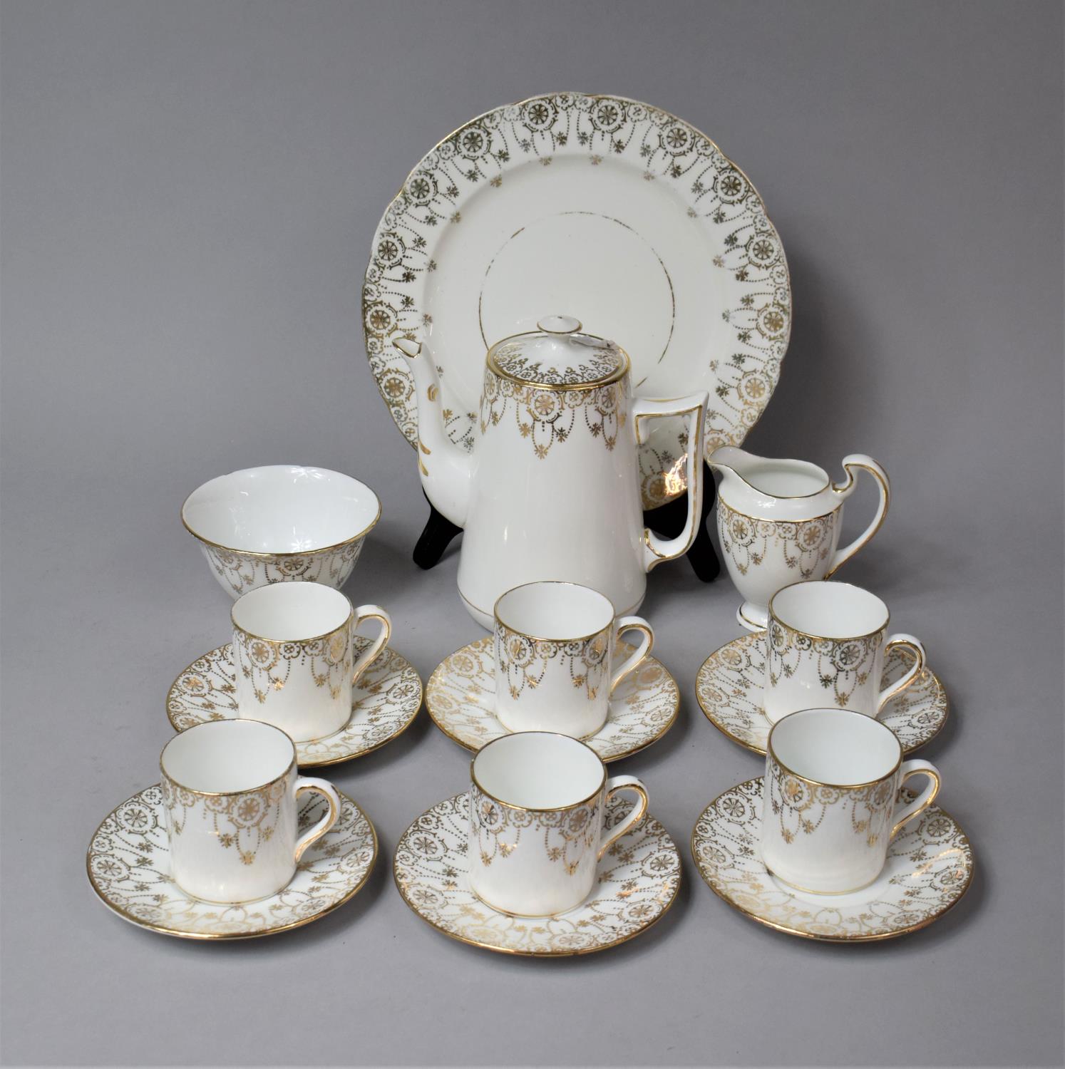 A Gilt and White Pendant Coffee Set to comprise Coffee Pot, Cake Plate, Milk Sugar, Six Coffee