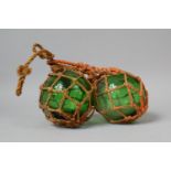 A Pair of Green Glass Globular Bottles in String Carrying Net, 15cm Diameter