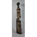 A Heavy Carved Wooden Tribal Club in the Form of Two Graduated Masks, 65cm high