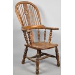 A 19th Century Elm Seated Broad Arm Windsor Chair with Pierced Splat, Outswept Arms, Solid Feet