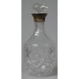 A Silver Topped Cut Glass Decanter with Stopper, 26.5cm high