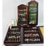 A Collection of Four Mahogany Cased Sets of Souvenir Teaspoons