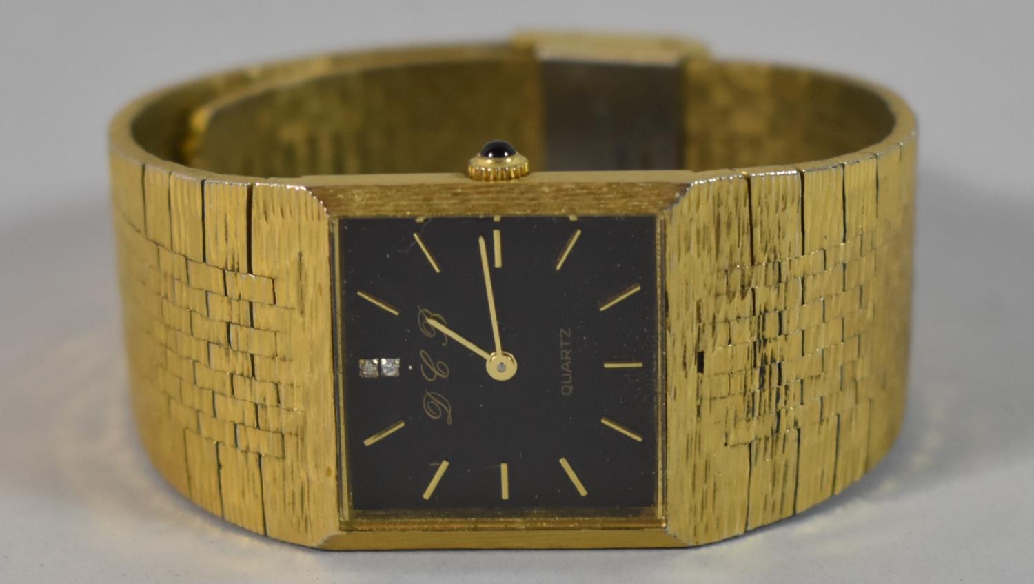 A Gents Yellow Metal Wrist Watch with Jewelled Black Dial