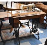 A Vintage Oak and Cast Iron Treadle Sewing Machine Base with Later Electric New Home Sewing