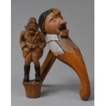 A Carved Wooden Black Forest Wine Saver Cork, Together with a Nutcracker