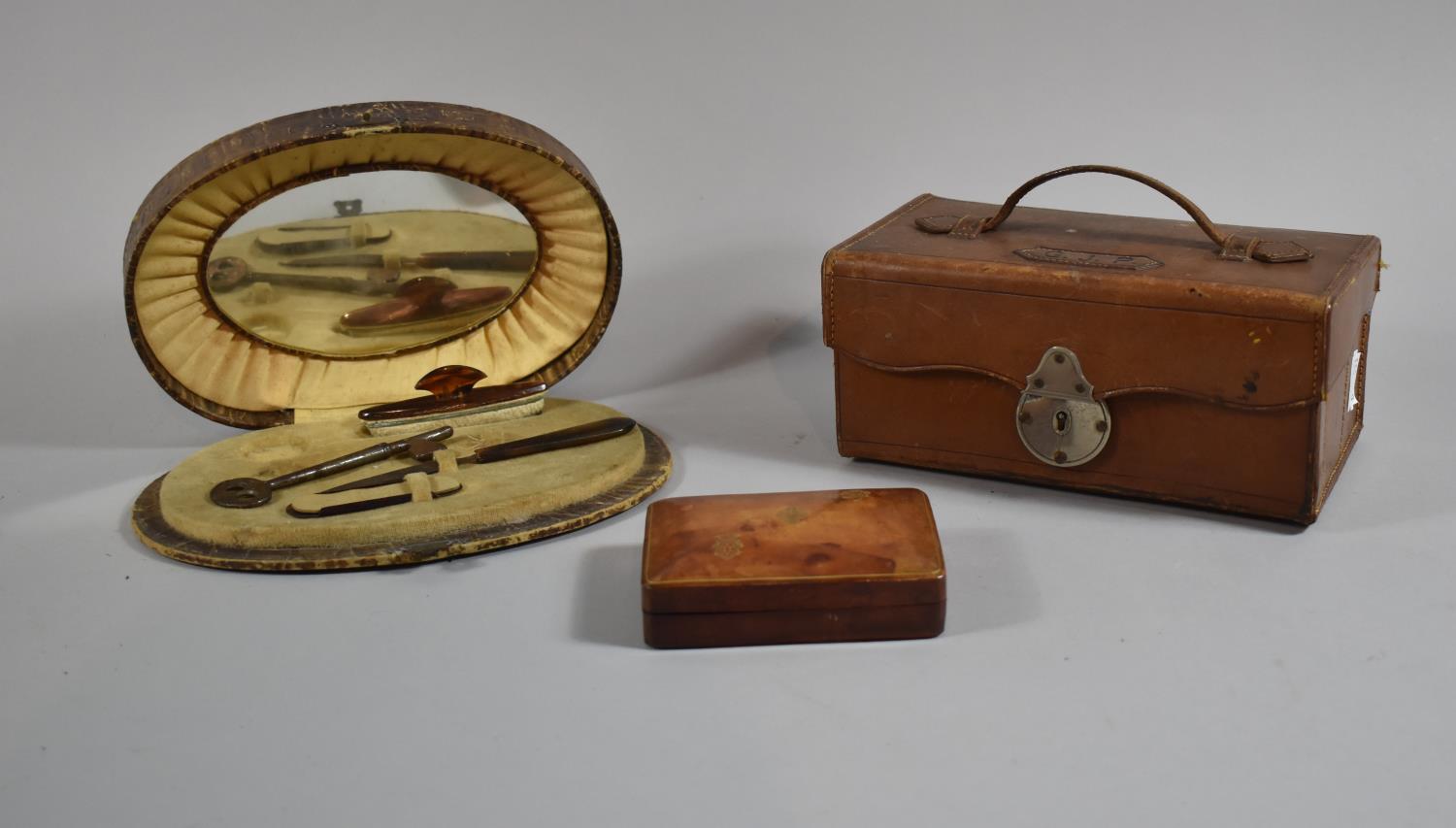 An Early 20th Century Oval Crocodile Skin Manicure Set Together with an Italian Leather Stud Box and