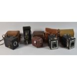 A Collection of Four Boxed Cameras and a Vintage Folding Camera