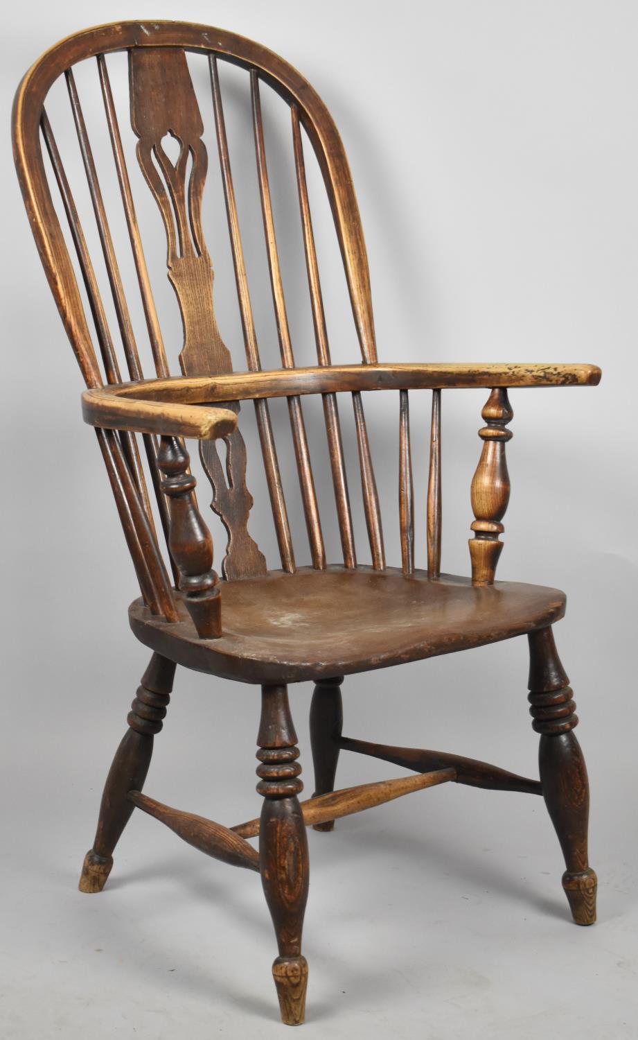 An Elm Seated Hooped Back Windsor Armchair with Pierced Splat