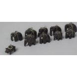 A Collection of Ten Miniature Carved Elephants Together with a Bog Oak Carved Pig Pendant (Missing