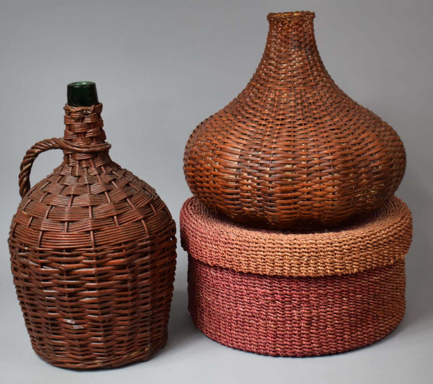 A Wicker Covered Glass Bottle, Wicker Lamp Shade and Cylindrical Box