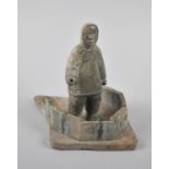 An Inuit Carved Stone Study of a Standing Eskimo in Igloo Base, Paper Label to Base for the