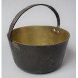 A Small Brass Jam Kettle with Loop Handle, 18cm Diameter
