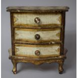 A French Gilt Decorated Serpentine Fronted Miniature Chest of of Three Drawers, 20cm Wide and 19cm