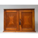 An Edwardian Mahogany Smokers Cabinet with Hinged Lid and Panelled Doors Opening to Reveal Fitted