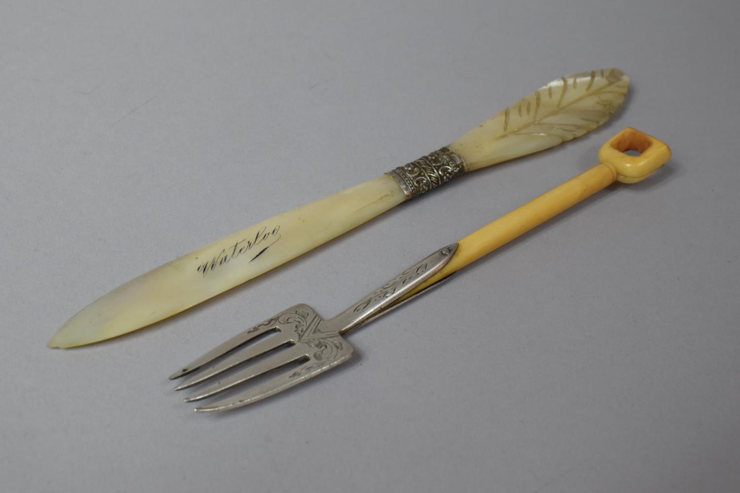 A Silver and Ivory Four Pronged Fork Together with a Mother of Pearl Souvenir Letter Opener for
