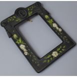 An Unusual Bois Durci Simulated Whitby Jet Photo Frame Decorated with Birds and Foliage and Having
