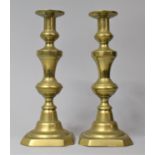 A Pair of Victorian Brass Candlesticks with Pushers, 28cm high