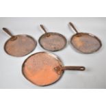 A Collection of Four Graduated Copper Victorian Saucepan Lids, the Largest 27cm Diameter