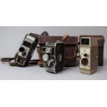 A Collection of Three Leather Cased Bell & Howell 8mm Clockwork Cine Cameras, In need of Some