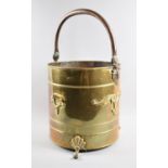 A Mid 20th Century Cylindrical Brass Coal Bucket with Loop and Side Carrying Handles, Scrolled Feet,