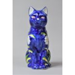 A Modern Blue Glazed Floral Decorated Study of a Seated Cat, 25cm high