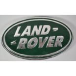 A Reproduction Aluminum Oval Land Rover Plaque, 30cm wide