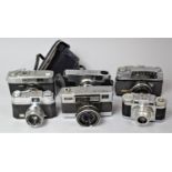 A Collection of Six Vintage Cameras to Include Olympus Quickmatic, Fujica Auto-M, Minolta, Taron and