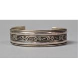 A Silver Bangle with Scrolled Decoration