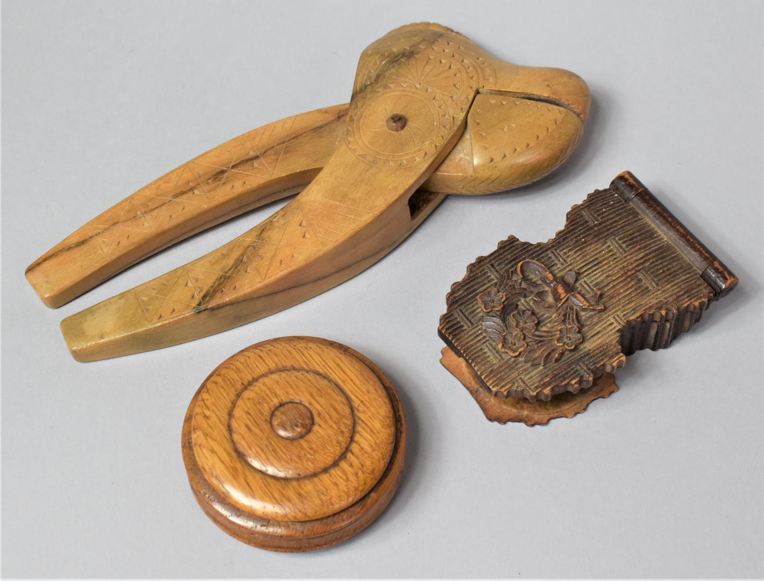 A Carved Wooden Pocket Watch Holder (AF) Together with a Carved Nutcracker and a Circular Wooden Box