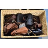A Wicker Basket Containing Various Vintage Camera Cases