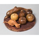 A Circular Wooden Cheese Board and Collection of Treen Fruit, Carved Dolphin and Cat