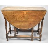 A Mid 20th Century Oak Drop Leaf Oval Topped Gate Legged Dining Table