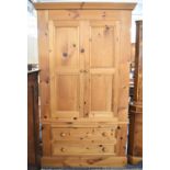 A Modern Pine Wardrobe with Panelled Doors to Hanging Top Section and Two Long Drawers to Base,