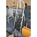 A Three Step Metal Framed Step Ladder and a Vintage Vacuum Cleaner