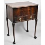 A Mahogany Lift Top Sewing Box with Two Base Drawers on Cabriole Supports with Claw and Ball Feet,