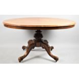 A Victorian Burr Walnut Oval Snap Top Breakfast Table on carved Quadrant Base, 131cm Long