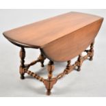 A Nice Quality Ercol Oval Topped Drop Leaf Coffee Table on Turned Support, 107cm long