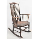 A Mid 20th Century Wheel Back Spindle Rocking Chair