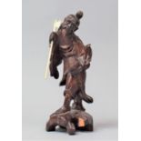 A Carved Oriental Figure of an Elder with Hat and Basket, 18.5cm high, Loss to Base