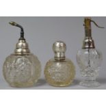A Collection of Three Silver Topped Glass Perfume Bottles