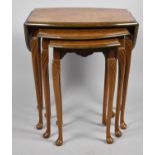 A Nest of Three Modern Walnut Tables, Largest with Oval Top and Drop Leaves, 52cm Wide