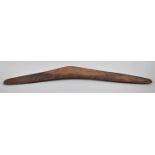 An Australian Aboriginal Boomerang with Carved Decoration, 70cm Wide