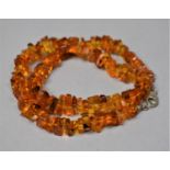 A Carved Amber Chip Necklace with Silver Clasp