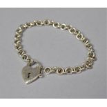 A Silver Charm Bracelet with Heart Shaped Clasp