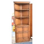 An Ercol Double Freestanding Elm Corner Unit with Panel Doors to Cupboard Base, 70cm Wide