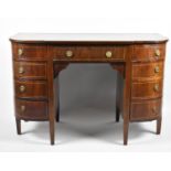 An Edwardian Breakfront Crossbanded Kneehole Writing Desk, with Centre Drawer Flanked by Four