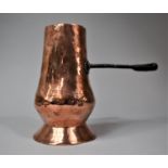 An Early Iron handled Copper Side Pouring Jug, 18cm high