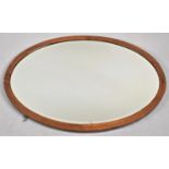 An Edwardian Inlaid Oval Wall Mirror, 88cm Wide