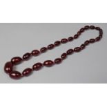 A String of Cherry Amber Bakelite Beads, 34.4g