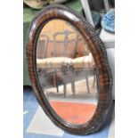 An Edwardian Cushioned Framed Oval Wall Mirror, 84cm high